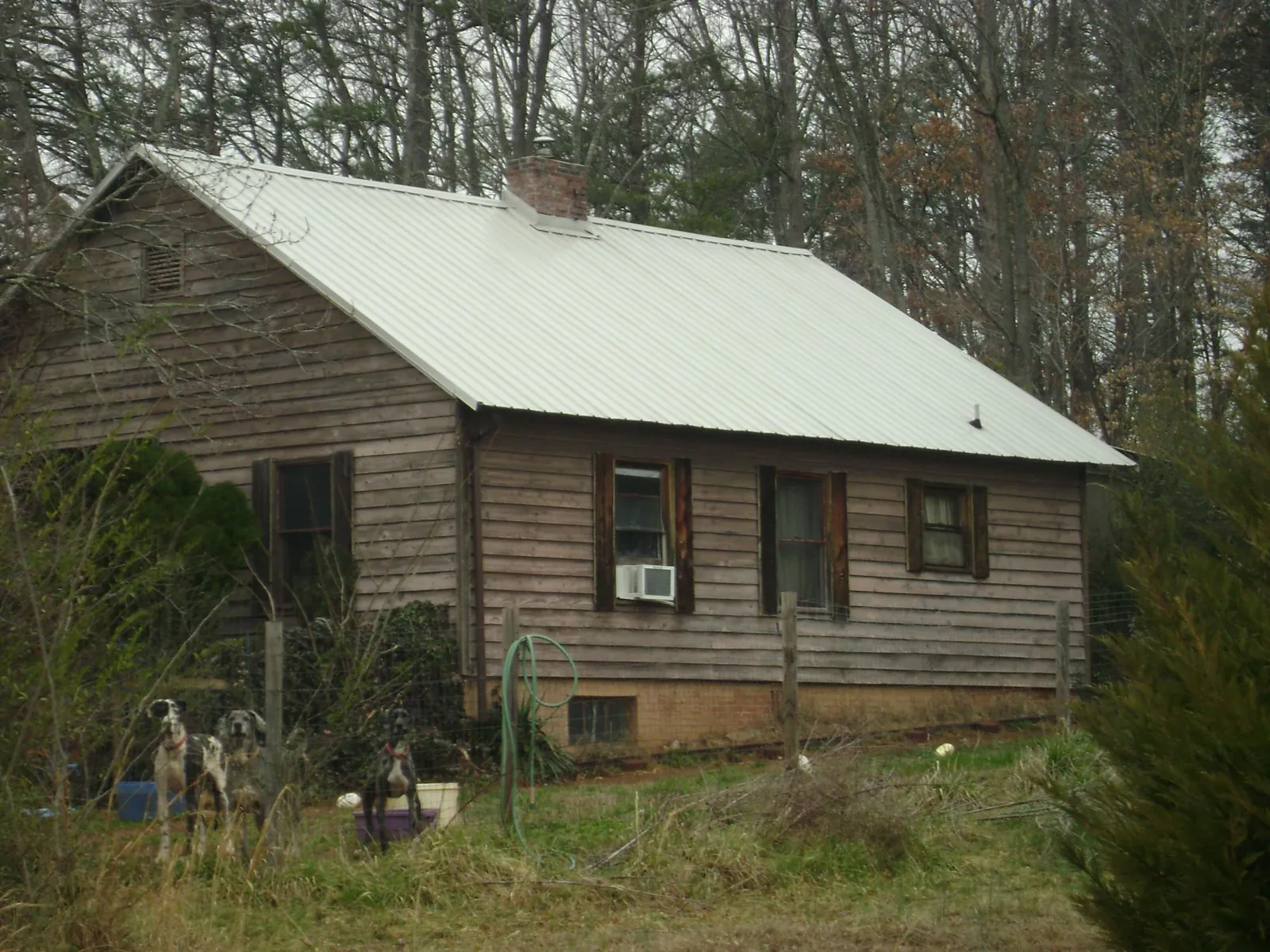 White metal roof on an old wood sided farmhouse, from a Metal Roof Installation job in Mount Kisco